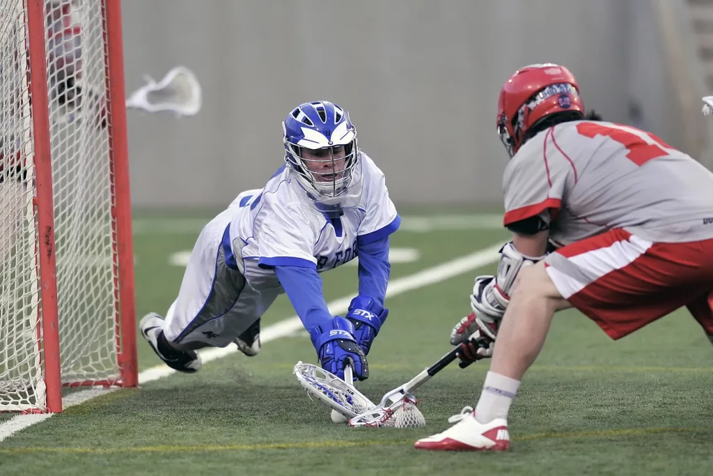 lacrosse player trying to safe goal